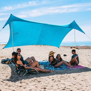 large group enjoying shade on folly beach