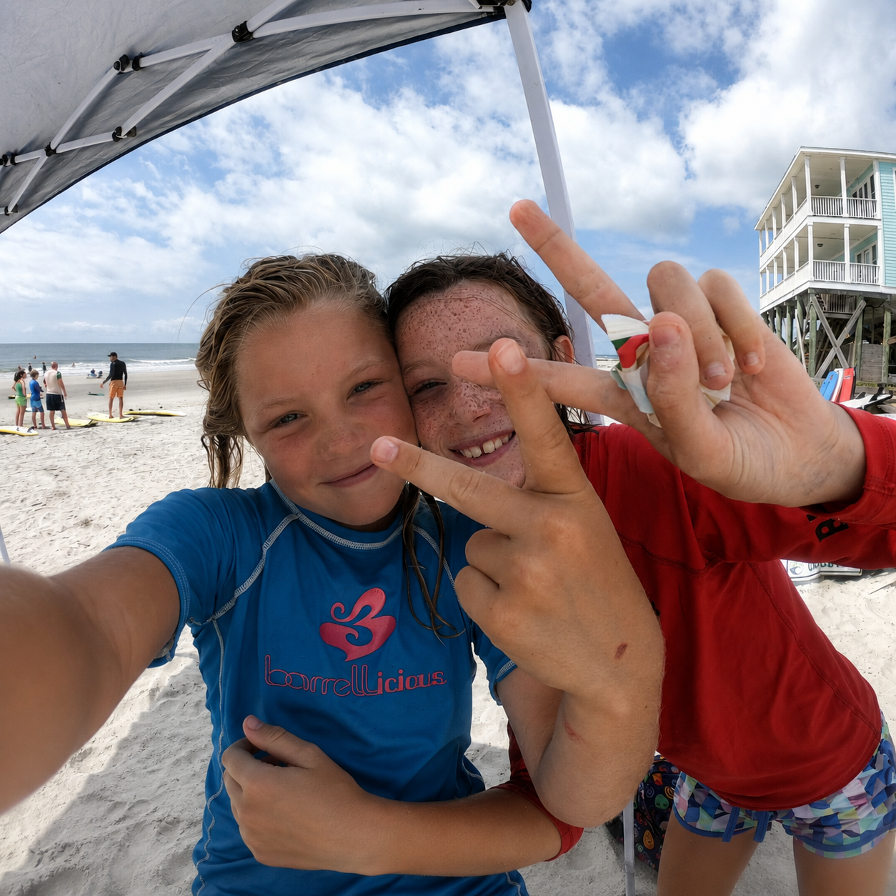 Two smiling campers at Carolina Salt surf camp on Folly Beach, posing for a selfie